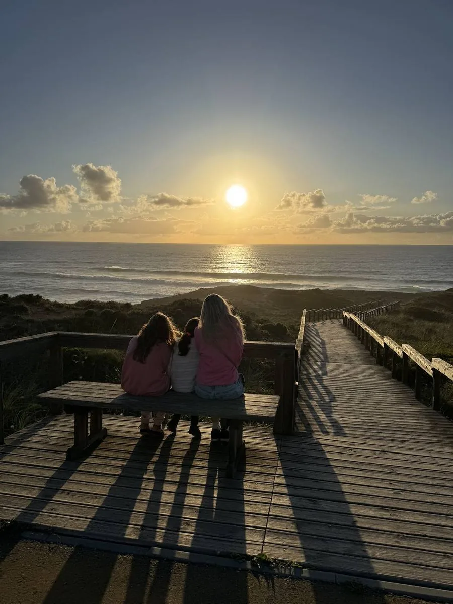 Family watching sunset on the boardwalk